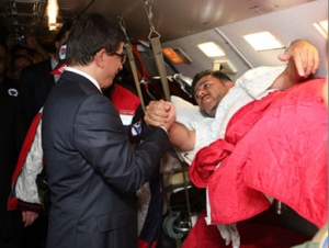 Глава МИД Турции жмет руку раненому миротворцу