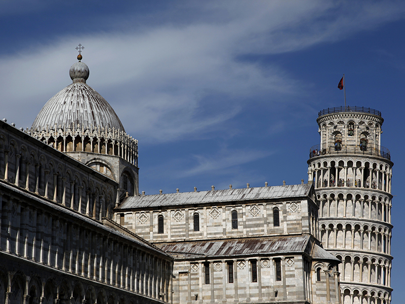 The Leaning Tower of Pisa is seen behind the Cathedral on July 19, 2012.  The 'Torre di Pisa' is the bell tower of the Cathedral of the Italian city of Pisa, known worldwide for its unintended tilt to one side. The tower began to lean in 1178 due to soft ground which could not properly support the structure's weight. Photo courtesy of REUTERS/Clarissa Cavalheiro