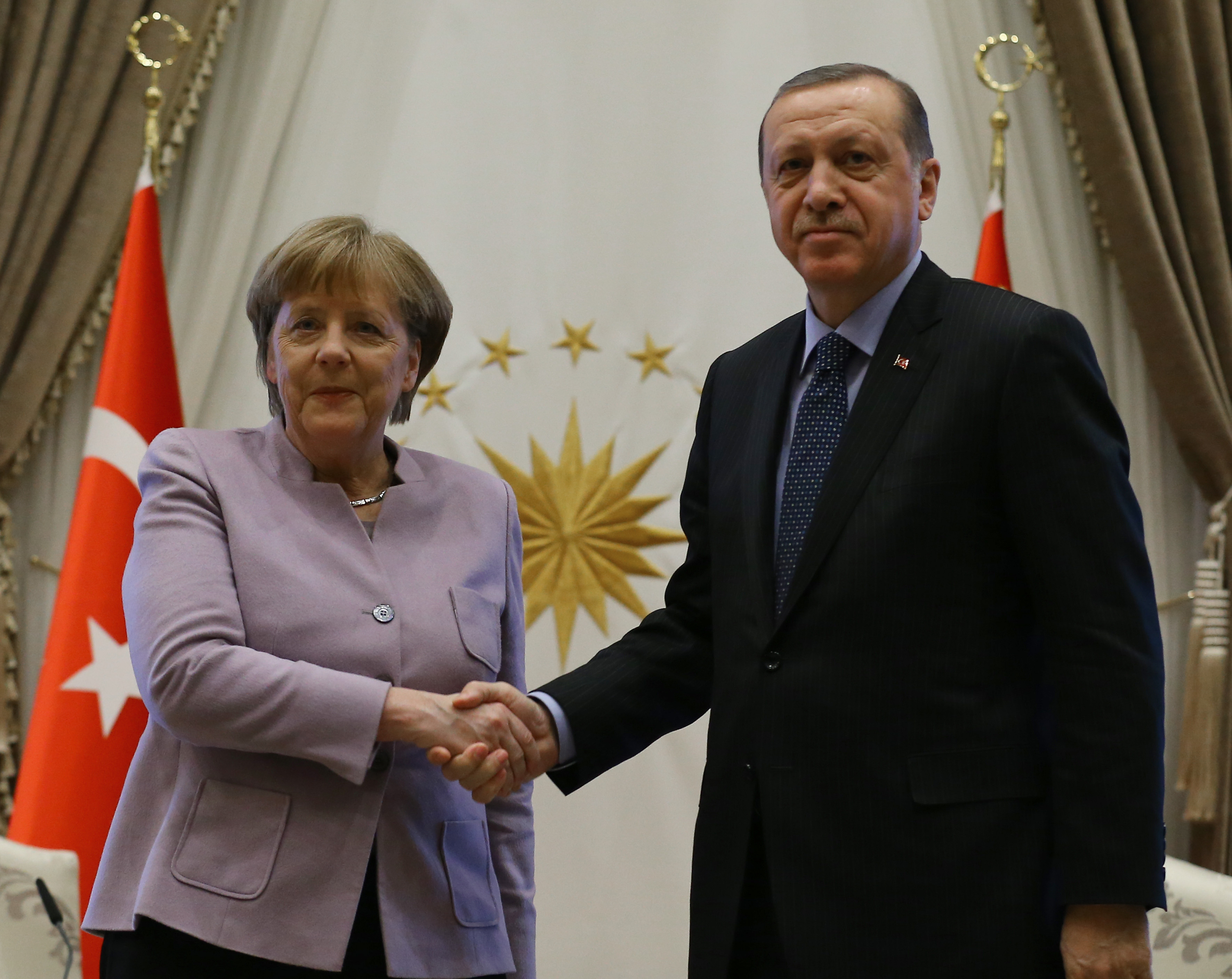 ANKARA, TURKEY - FEBRUARY 2 : Turkish President Recep Tayyip Erdogan (R) and German Chancellor Angela Merkel (L) shake hands during a press conference after their meeting at the Presidential Complex in Ankara, Turkey on February 2, 2017. ( Halil Sağırkaya - Anadolu Agency )