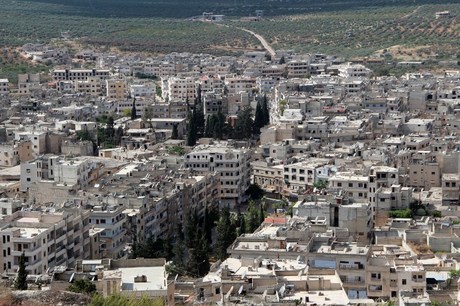 A picture taken on May 29, 215 from the top of a hill shows a general view of the town of Ariha, in the northwestern province of Idlib, a day after the city was seized by a rebel coalition led by Al-Qaeda's Syria franchise. Ariha, the last remaining government-held city in the province of Idlib, was captured after fierce clashes with regime forces, including Hezbollah fighters, who were then seen pulling out.  AFP PHOTO / AL-MAARRA TODAY / GHAITH OMRAN