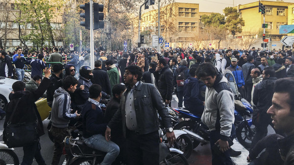 In this photo taken by an individual not employed by the Associated Press and obtained by the AP outside Iran, demonstrators gather to protest against Iran's weak economy, in Tehran, Iran, Saturday, Dec. 30, 2017. A wave of spontaneous protests over Iran's weak economy swept into Tehran on Saturday, with college students and others chanting against the government just hours after hard-liners held their own rally in support of the Islamic Republic's clerical establishment. (AP Photo)